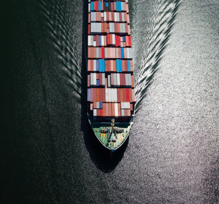 Aerial photo of the front end of a large fully loaded container ship.