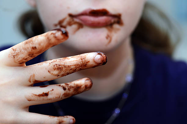 Girl eating chocolate stock photo