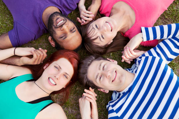 istock Four Friends On Grass Looking Up 171585747