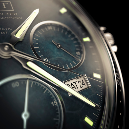 Close view of a men's wristwatch with luminescent hands on a dark background.  Designed and modelled in 3D by myself. All markings and designs are fictitious.  Very high resolution 3D render.