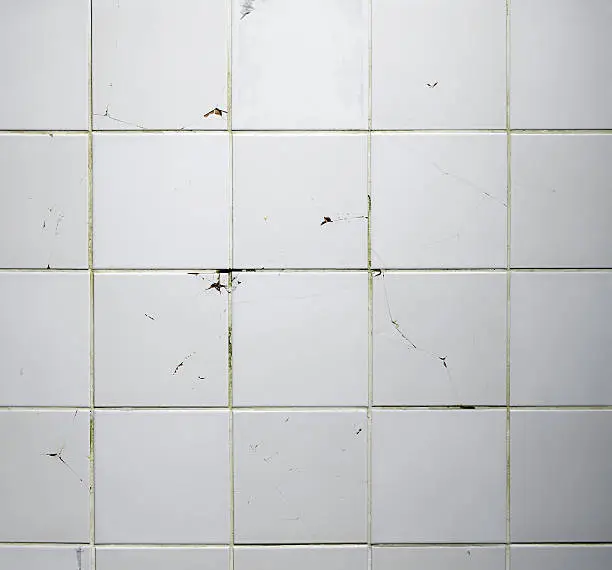 Photo of Texture of the old tile wall with cracks