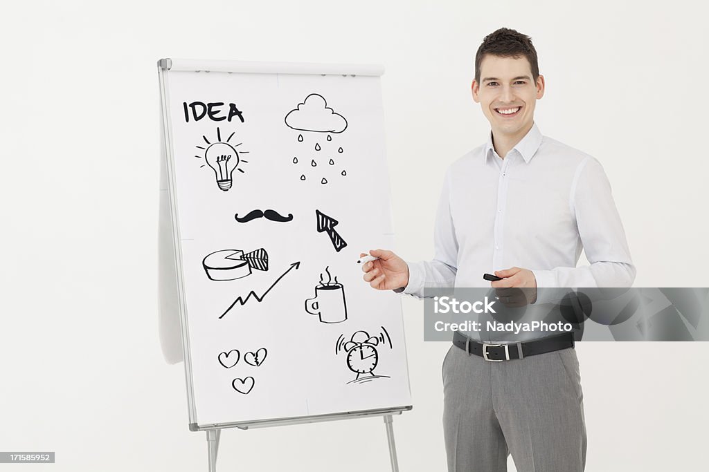 Presentation Young successful businessman smiling while drawing presentation. Adult Stock Photo