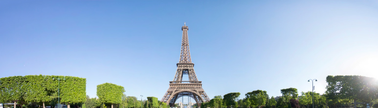 High resolution panorama of the Eiffel Tower with a sunny blue sky