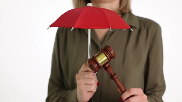Lawyer or judge with umbrella and court gavel