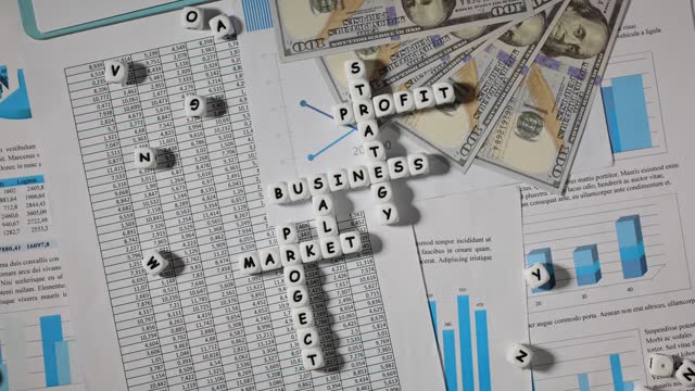 Crossword from blocks on accounting papers with statistics and charts and dollars