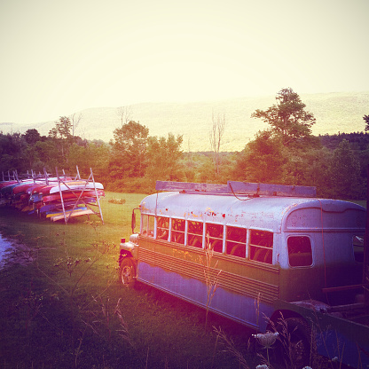 Colorful old Bus with kayaks. Vermont Scene.