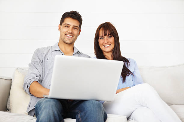 istock Couple with a laptop sitting on the sofa 171586794
