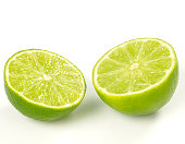 Close-up of two lime halves isolated on white