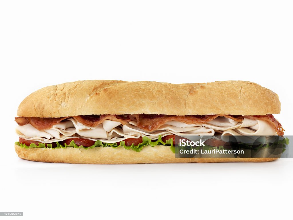 Foot long Turkey Club Submarine Sandwich 12 inch -Turkey and Bacon Submarine Sandwich with Lettuce and Tomato on Crusty Bread-Photographed on Hasselblad H3D2-39mb Camera Sandwich Stock Photo