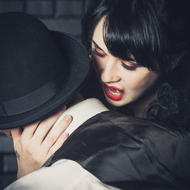Vampire A young female preparing to bite her victim. male vampire biting his victim stock pictures, royalty-free photos & images