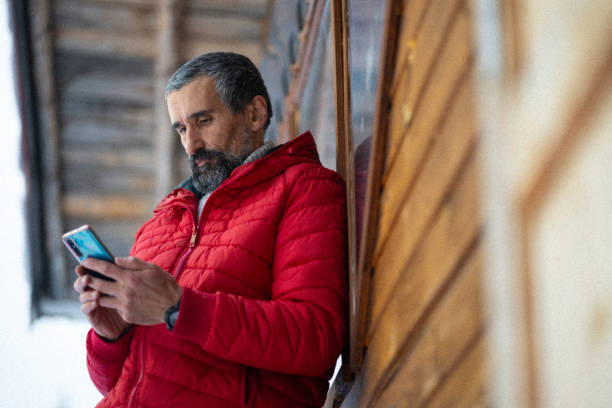 istock Cabin getaway. Man enjoys a log cabin retreat. 1715870412