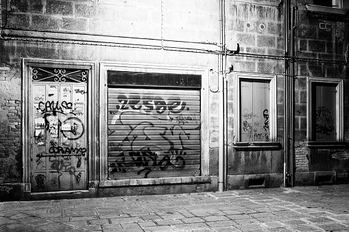 Stavanger, Norway, March 10 2023, Closed Shop Retail Business With Street Art Graffiti Covering Store Window And No People