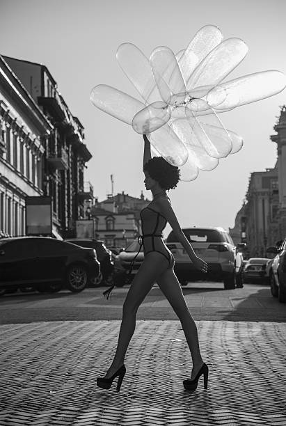 girl going down the street with balloons the girl going down the street with balloons condom photos stock pictures, royalty-free photos & images