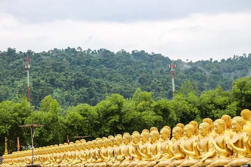 Many monks in temple with mountains and sky background in Thailand look amazing.