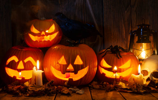 istock Halloween Jack-o-Lantern Pumpkins on rustic wooden background 1715881800