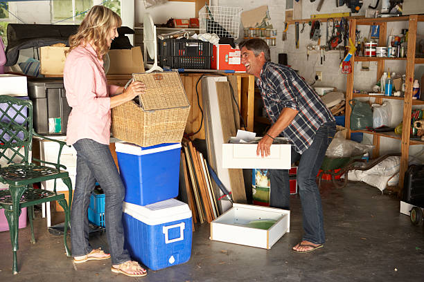 Couple Clearing Garage For Yard Sale Couple Clearing Garage For Yard Sale Laughing cluttered stock pictures, royalty-free photos & images