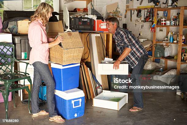 Couple Clearing Garage For Yard Sale Stock Photo - Download Image Now - Garage, Cleaning, Messy