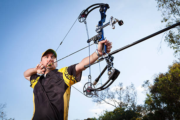 Archery Professional archer at draw. shooting a weapon photos stock pictures, royalty-free photos & images