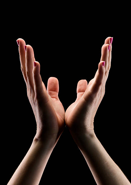 istock Two hands lifted up to heaven on a black background 171588365