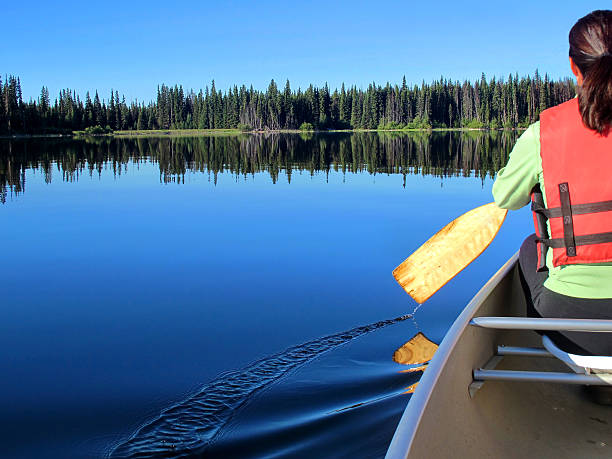 istock Woman enjoys nature while canoeing 171588419