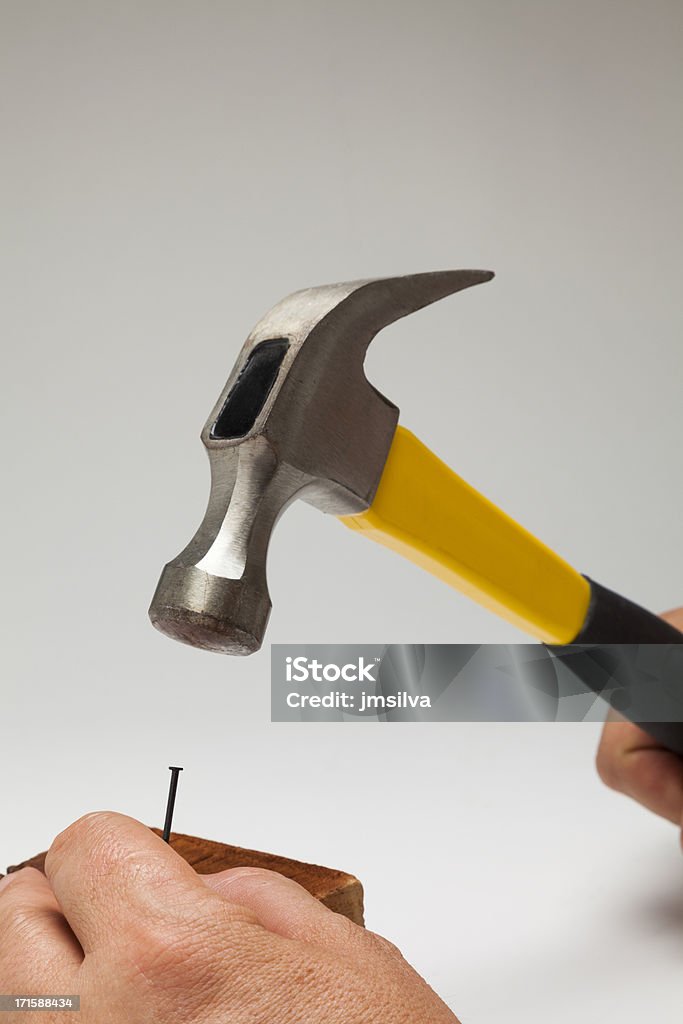 Hammer and nail Man hitting nail into wood with hammer Accuracy Stock Photo