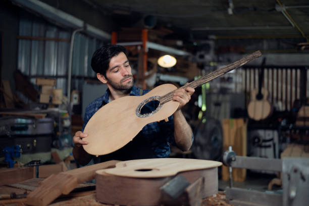 istock The process of making a classical guitar, Luthier checking guitar 1715884931