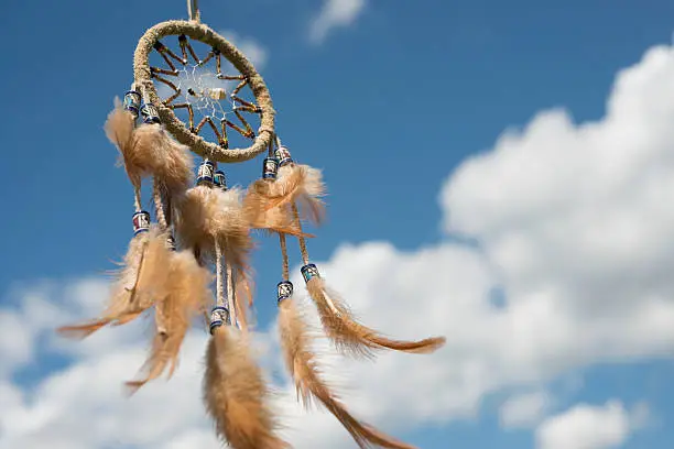 Dreamcatcher against great cloudscape. Shallow DOF.