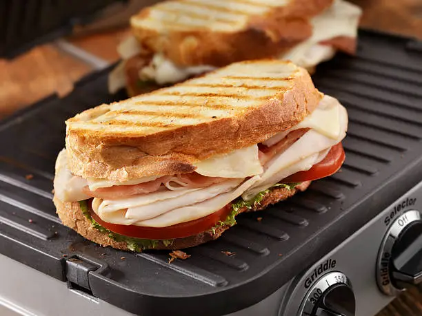 Turkey Club Panini with Lettuce and Tomatoes on a Panini Grill - Photographed on Hasselblad H3D2-39mb Camera