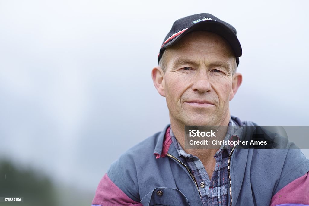 Organic Farmer Portrait Outdoors Portrait of a Swiss organic farmer, outdoors on his farm in the Alps. Farmer Stock Photo