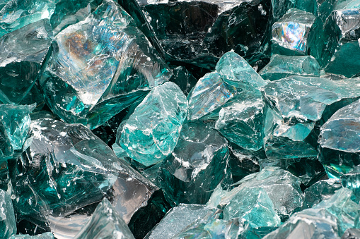 Heap of large Chunk of Aqua Glass Rock Slag for Garden decor. Glass in Nature Full frame texture top view