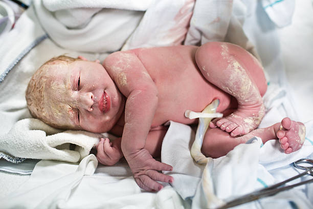 Newborn baby with umbilical cord stock photo