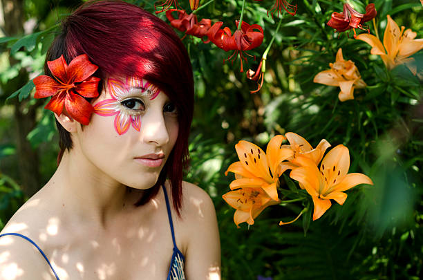 Horizontal saturated outdoor garden shot of young woman with light falling across eye.
