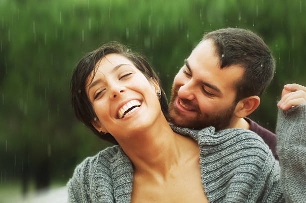 istock Young Romance Couple Smiling Under the Rain 171590324