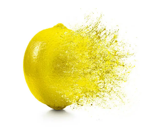 Photo of A splash coming off of a lemon on a white background