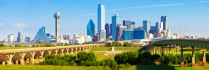 Panoramic view of the skyline of Dallas financial district during a beautiful bright blue day.