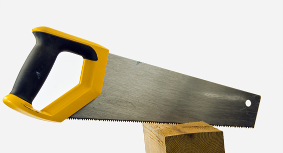 A small saw cutting a wood block. White background.
