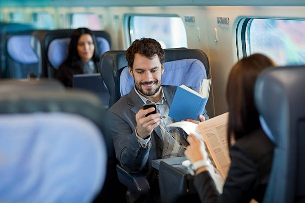 istock Businessman reading  book  on Train and using mobile phone 171590535