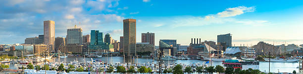 Baltimore's Inner Harbor in the early morning sunshine with wispy white clouds. This photo, taken during the celebration of the 200th Anniversary of the War of 1812, captures some of the numerous tall ships that sailed into the harbor to participate in the celebration. 