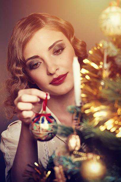 istock retro girl decorating a christmas tree 171590576