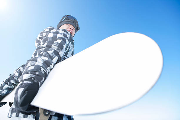 Smiling male snowboarder outdoor