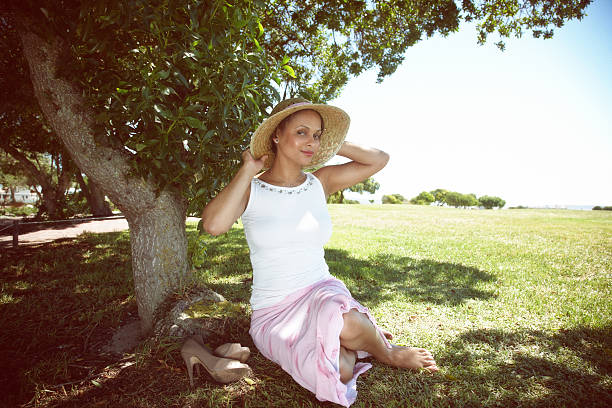 Attractive african woman under shady tree