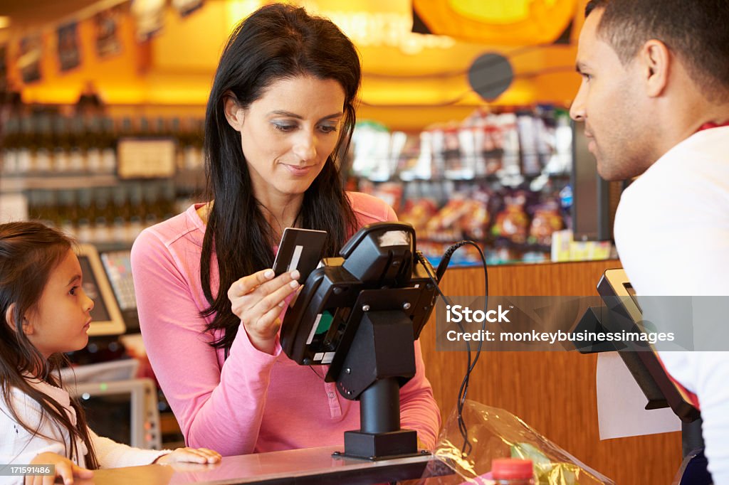 Madre pagar para la familia de compras en el momento de la compra - Foto de stock de Tarjeta de crédito libre de derechos