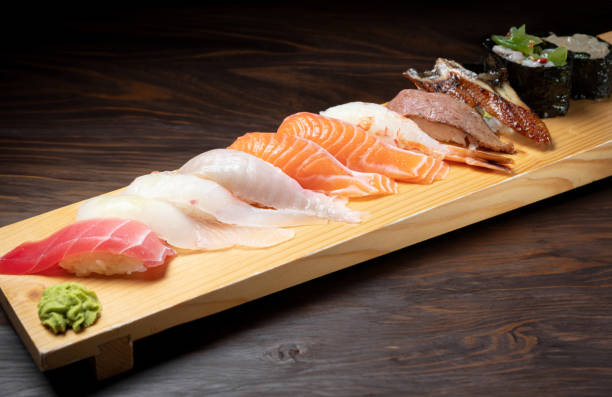 istock Different types of sushi on a wooden plate 1715918104