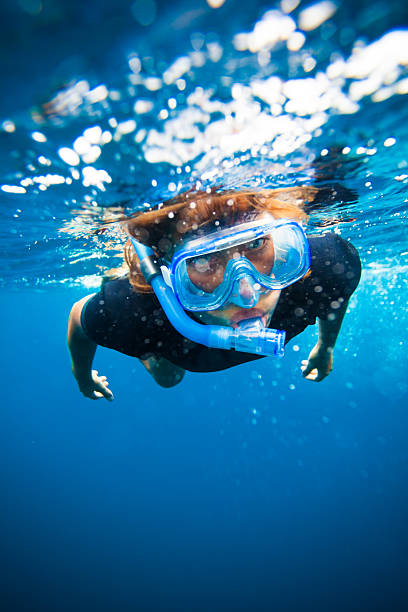 young  woman snorkeling underwater