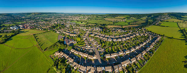 istock Suburban homes green fields blue skies aerial panorama 171592041