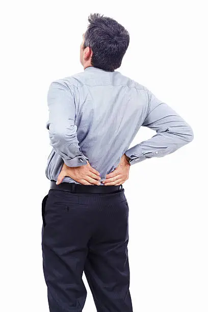 Rear-view of a businessman holding his lower back in pain