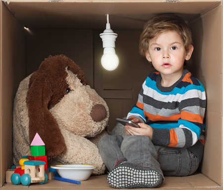 Little series depicting a Toddler (two years old) sitting in a small box. 