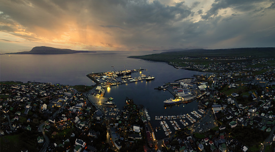 Aerial panoramic view of the harbour area and downtown Torshavn at sunset on Faroe Islands.