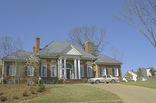 Exterior of home with manicured lawn in the suburbs.