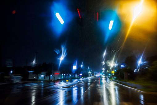 Rainy night, driving through blurred lights: moving through torrential rain after storm in Tampa, Florida